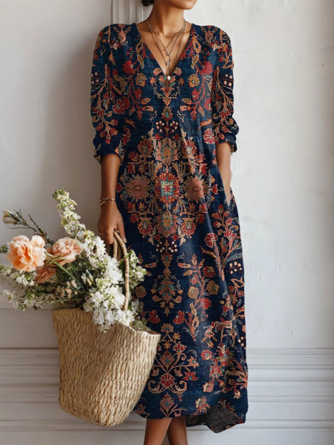 Women's floral V-neck midi dress in dark blue, three-quarter view showing sleeve and skirt detail