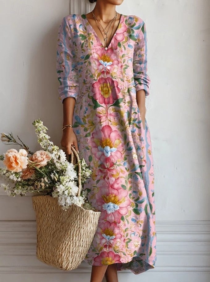 Women's floral long sleeve midi dress in pink with abstract print, styled for a casual look