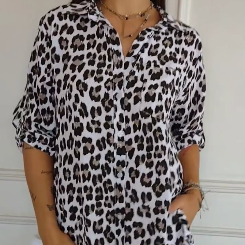 Woman wearing a white leopard print tie-front blouse with a relaxed, flattering fit