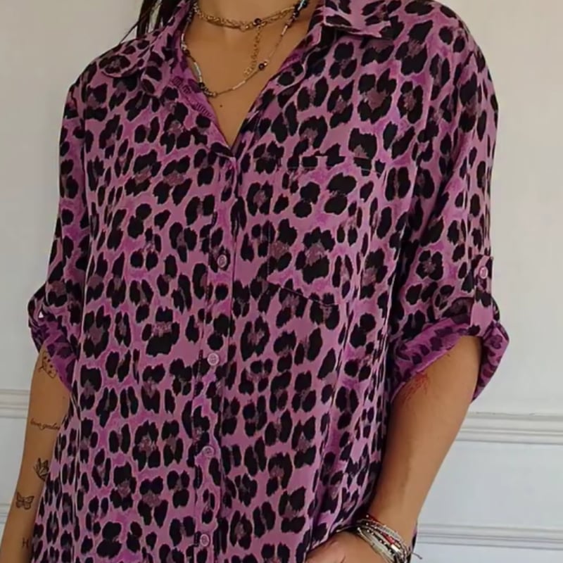 Woman in a brown leopard print blouse styled with denim jeans for a casual look