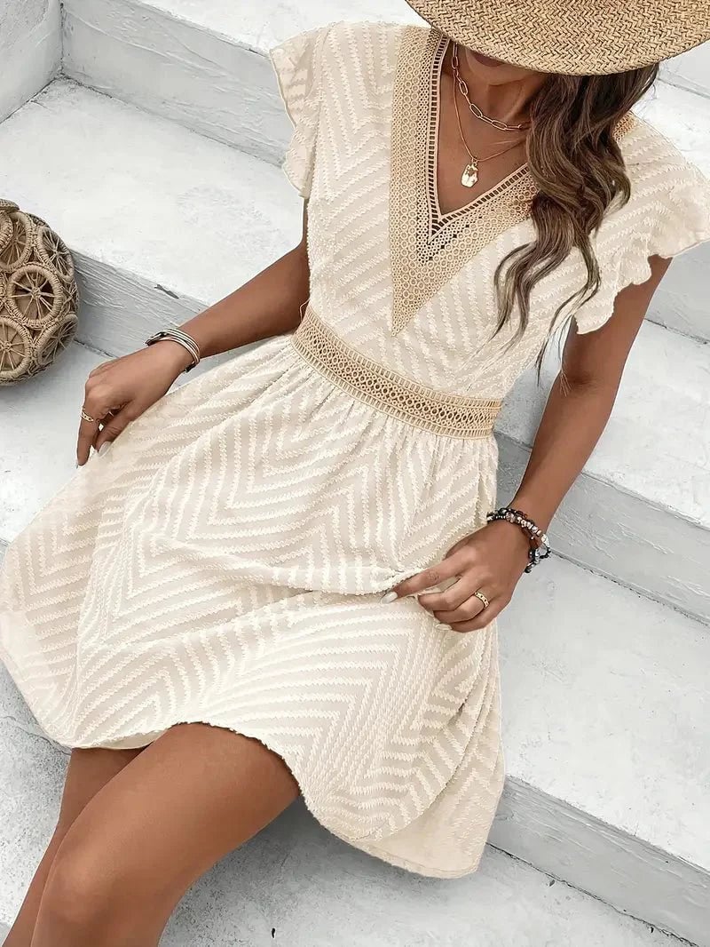 Side view of a woman in a flowy apricot sweetheart neckline dress showing silhouette