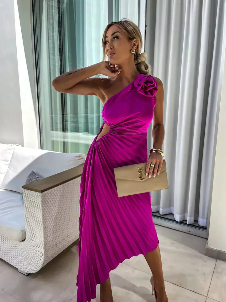 Model wearing the Charlotte floral draped cocktail dress in rose red at an outdoor gathering