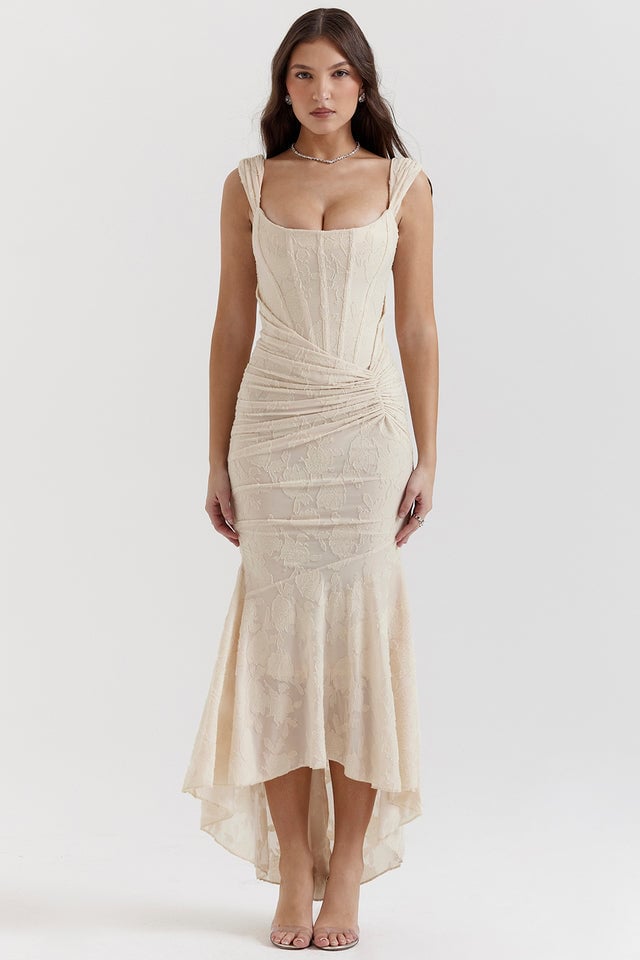 Side profile view of Charlotte ruched dress in beige highlighting the bodycon fit