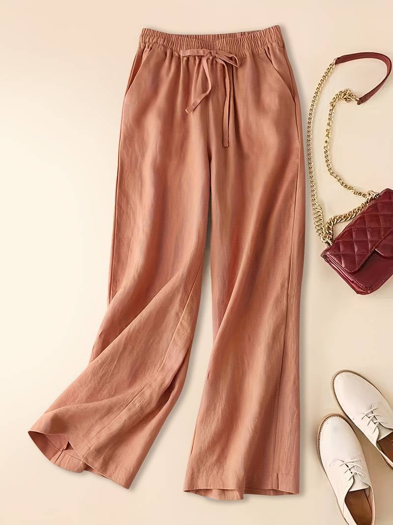 Relaxed drawstring pants in green color option styled with sandals