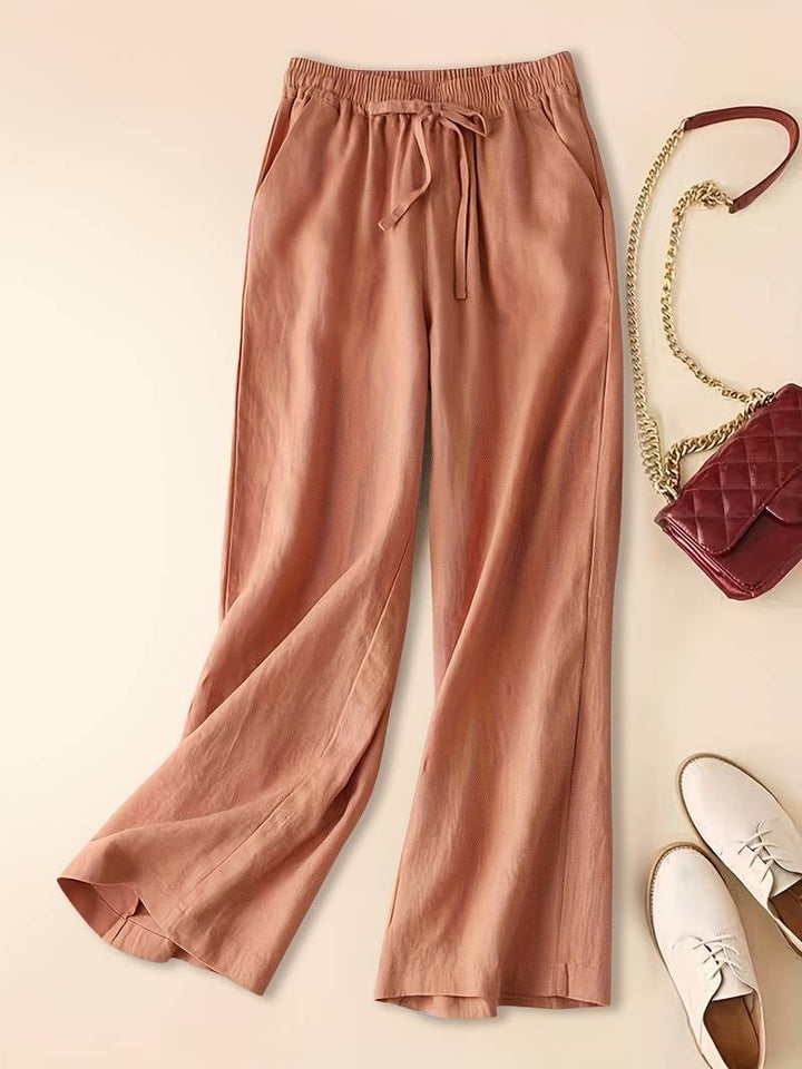Relaxed drawstring pants in green color option styled with sandals