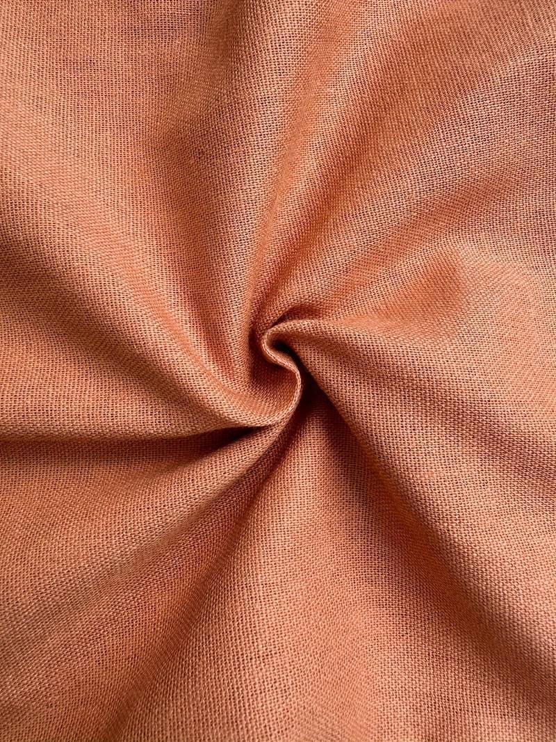 Flat lay of relaxed drawstring pants showing full length and fabric texture