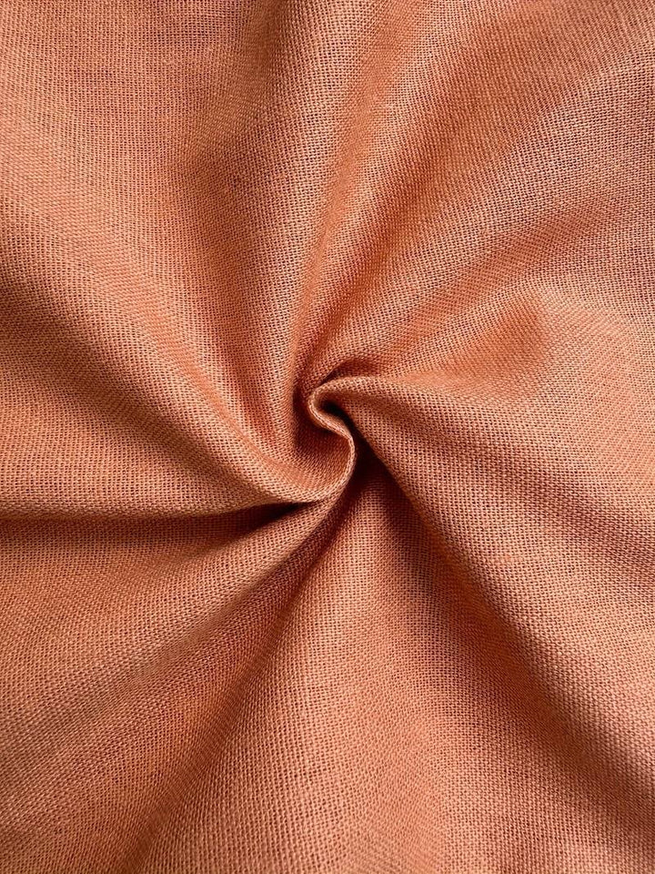 Flat lay of relaxed drawstring pants showing full length and fabric texture