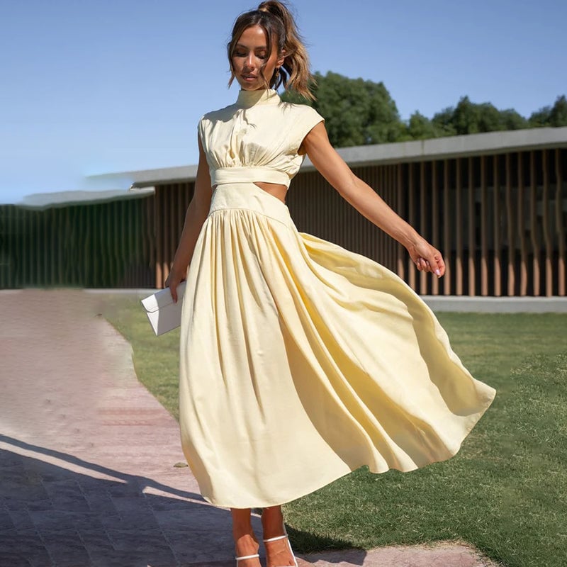 Woman wearing the halter dress in yellow, full-length front view