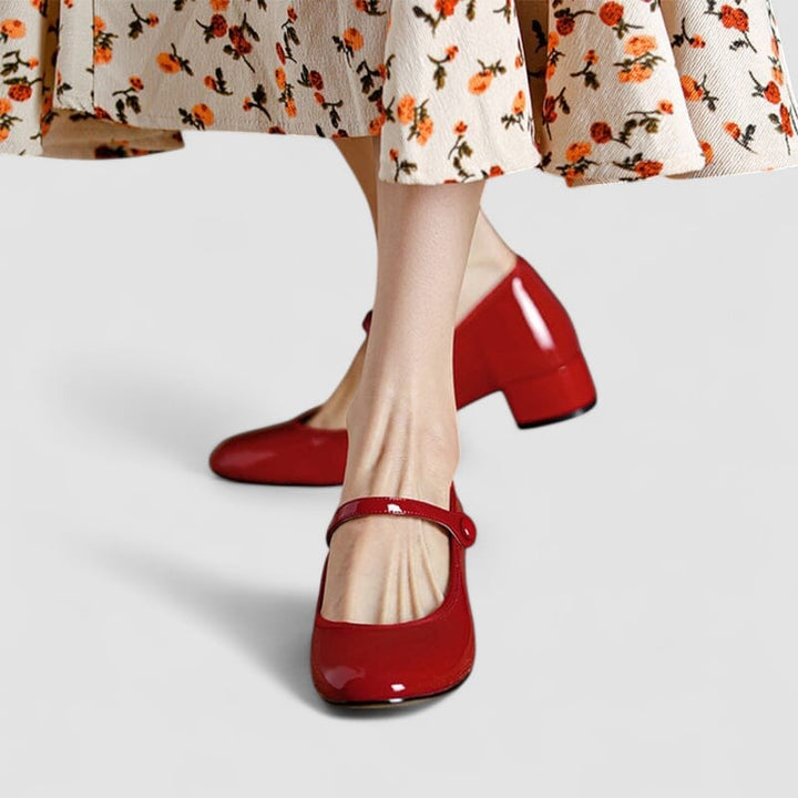 Classic elegant shoe in red displayed at an angle to highlight the elongating silhouette and polished finish