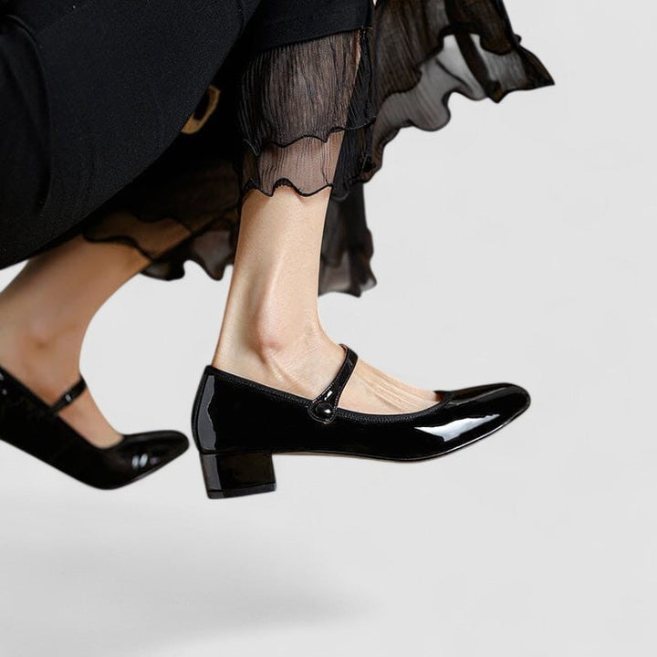 Side profile of black classic elegant shoe showcasing the sleek low heel and supportive sole construction