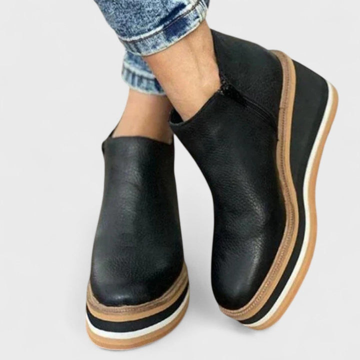 Chloe waterproof shoe in black displayed at an angle highlighting the supportive sole
