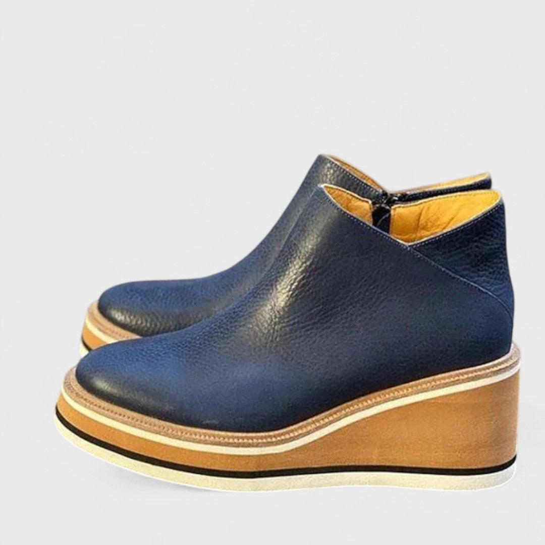 Pair of Chloe waterproof shoes in brown shown from above on a wet surface