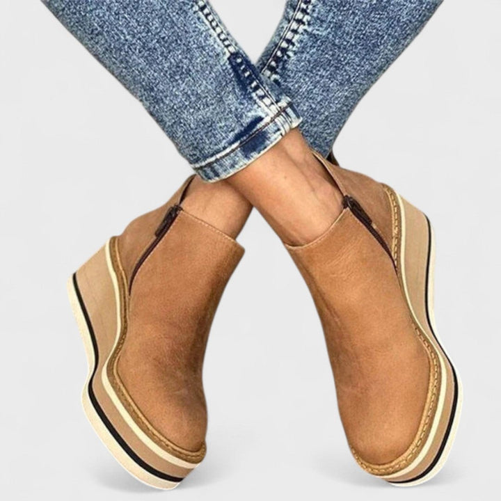Chloe waterproof shoe in blue side view showing sleek silhouette and balanced heel
