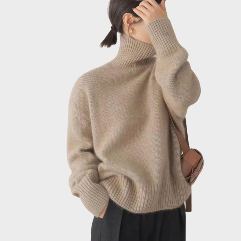 Side profile of a high collar sweater in beige showcasing smooth drape and silhouette