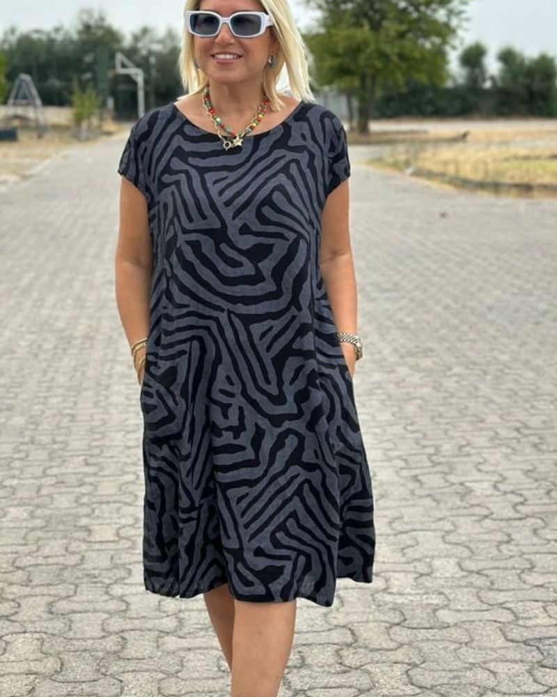Front view of a vintage-inspired printed summer dress with round neckline shown on a model