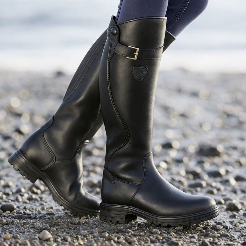 Florimay Christine waterproof boots in dark brown shown on a rainy urban sidewalk