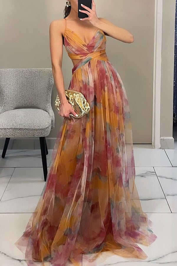 Side profile of woman in orange floral maxi dress showing graceful movement and elongated silhouette