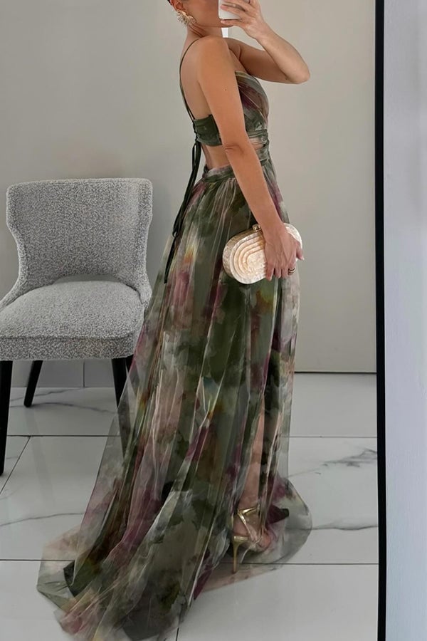 Model smiling in orange floral maxi dress styled with gold jewelry and heeled sandals