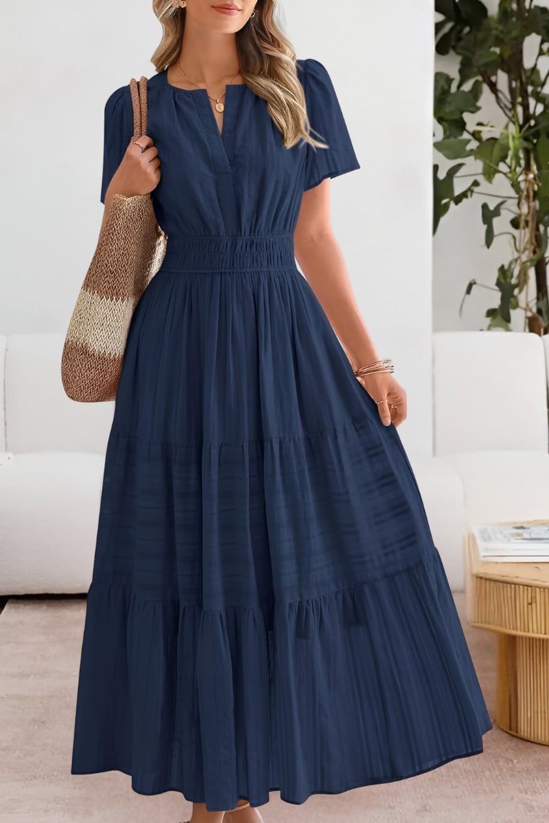 Model in a navy blue lightweight boho dress posed outdoors in warm weather
