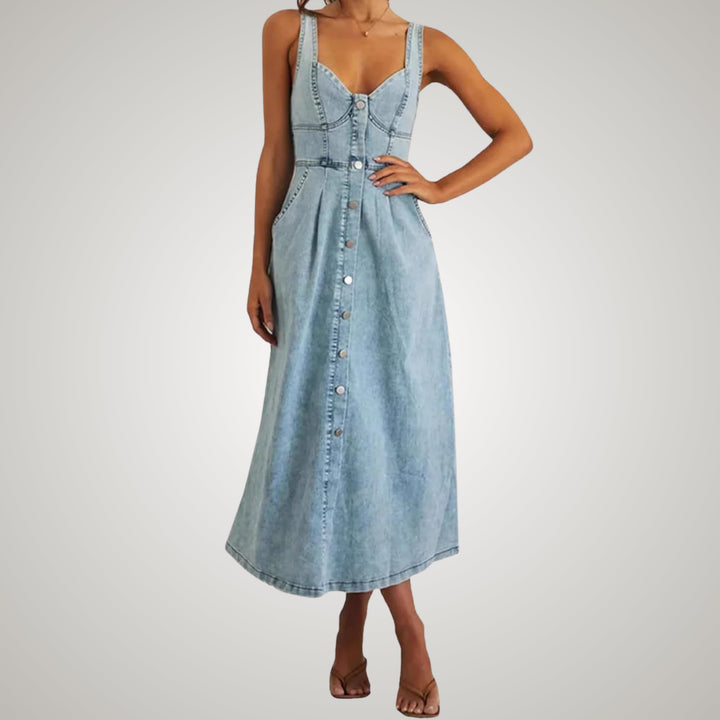 Model wearing a classic sleeveless denim dress paired with ankle boots, styled look