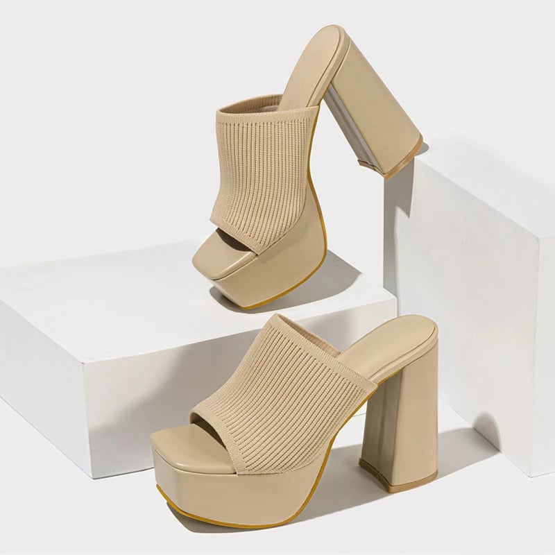 Close-up of Cinnamon platform sandal strap detail and platform height in black