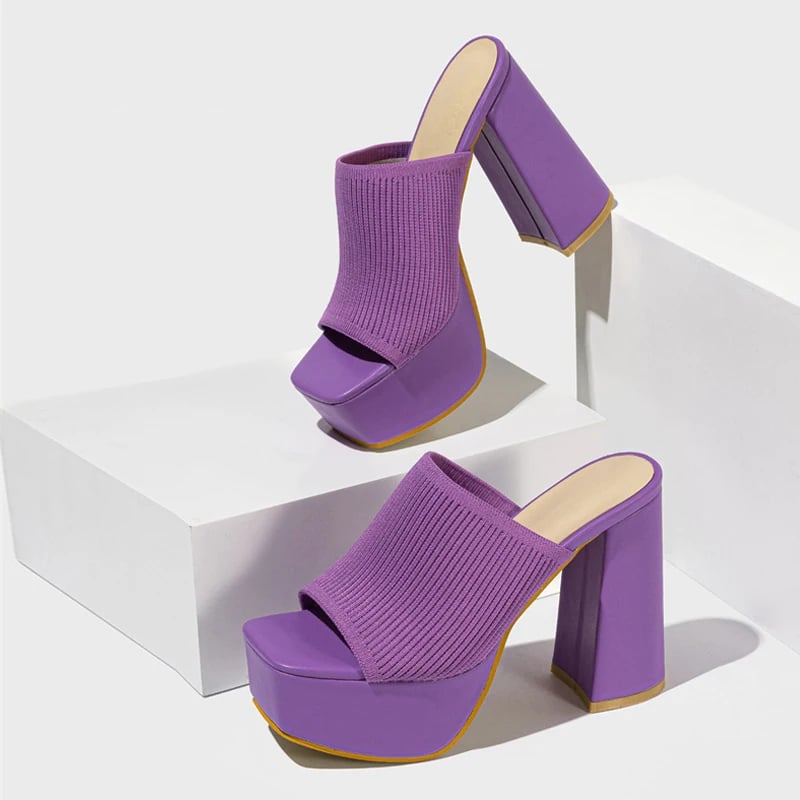 Pair of Cinnamon platform sandals in black arranged side by side, top-down view