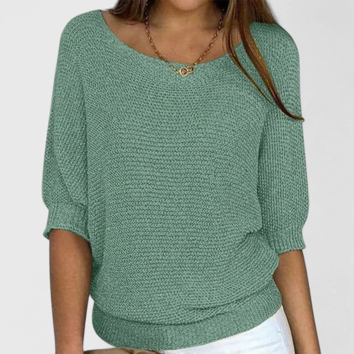 Front view of the Claire sweater in light green showing soft fabric and relaxed silhouette