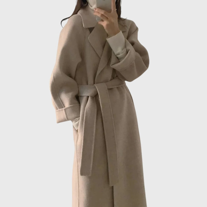 Front view of the Florimay belted overcoat in apricot showing adjustable belt and secure closures