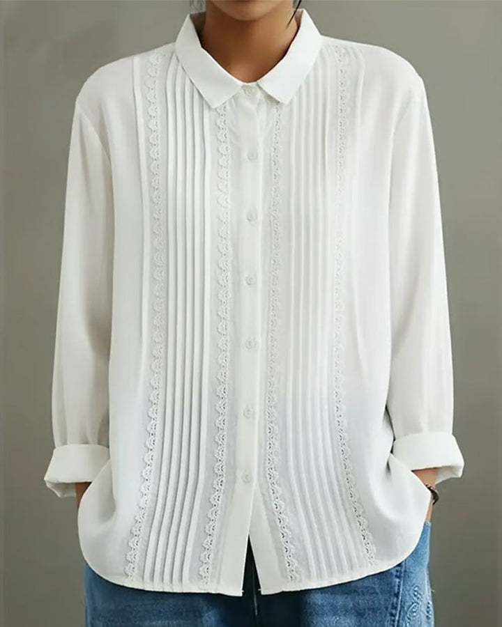 Model wearing the Claire button-up blouse in beige with sleeves rolled up for a relaxed look