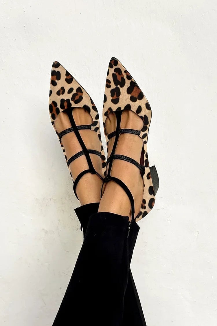 Khaki leopard strap heels with a sculpted heel and adjustable animal-print ankle strap, shown from a front three-quarter angle