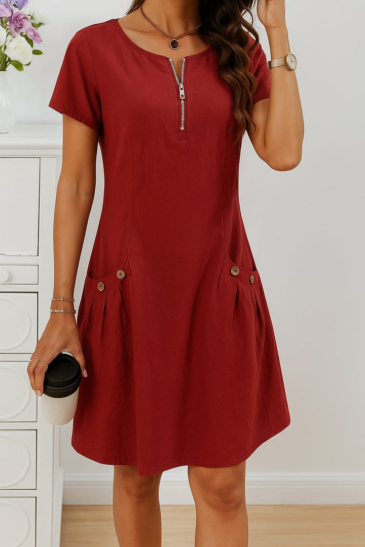 Green relaxed-fit summer dress with charming button details, modeled in an outdoor setting