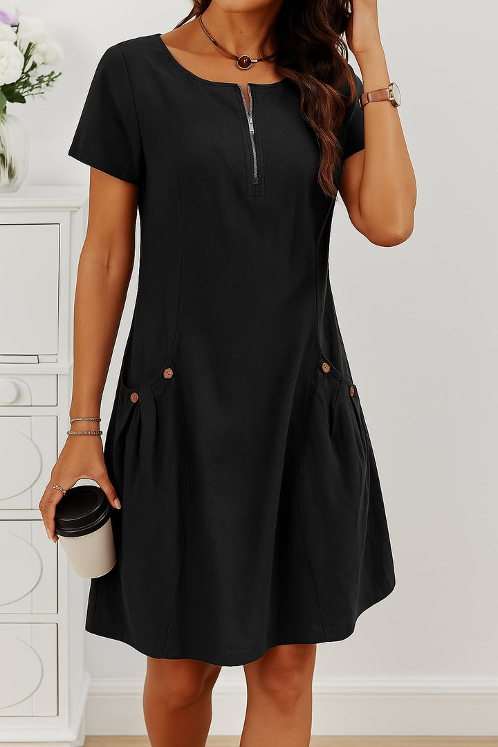 Woman wearing a black lightweight button-front summer dress, dressed down with casual sandals