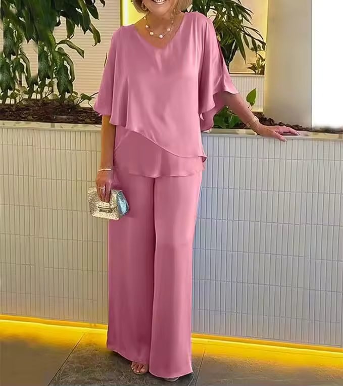 Model posing in the Clarissa two-piece set in purple, highlighting the figure-flattering silhouette
