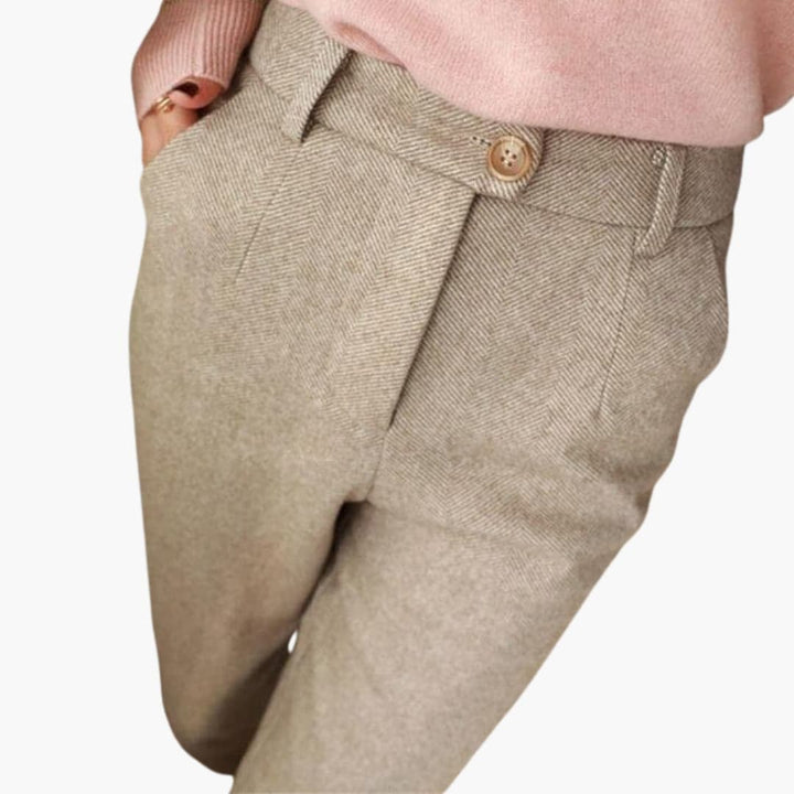 Model wearing Clarisse tailored pants in beige, paired with a fitted top for a chic office outfit