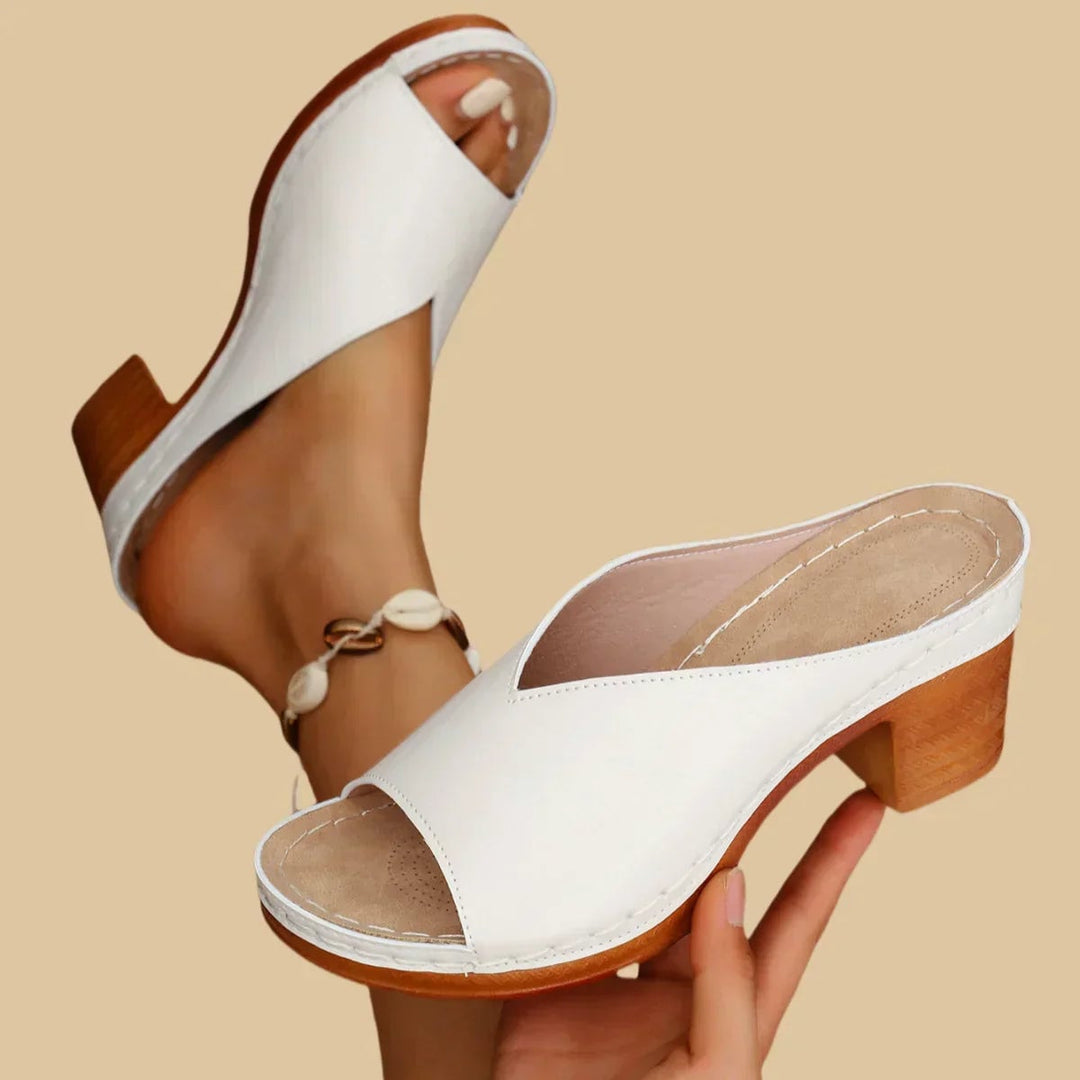 Claudette flat sandals in white displayed on a clean neutral background