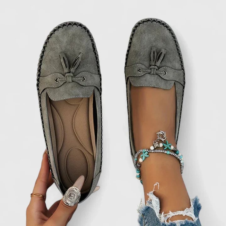 Clea suede bow loafers in grey with delicate bow and tassel toe accent, flat moccasin silhouette