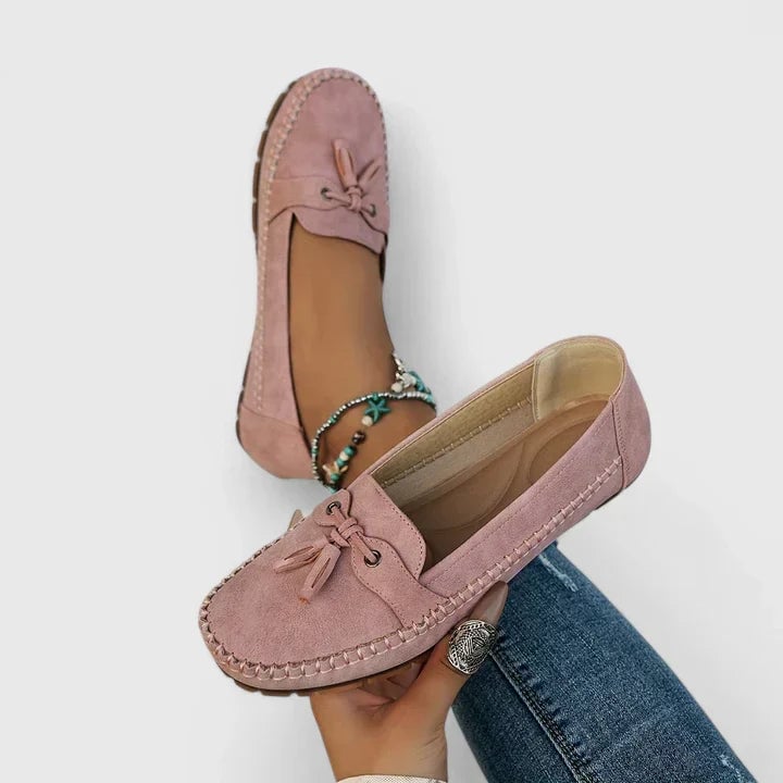 Side view of Clea slip-on moccasin loafers showing hand-stitched perimeter detailing in pink