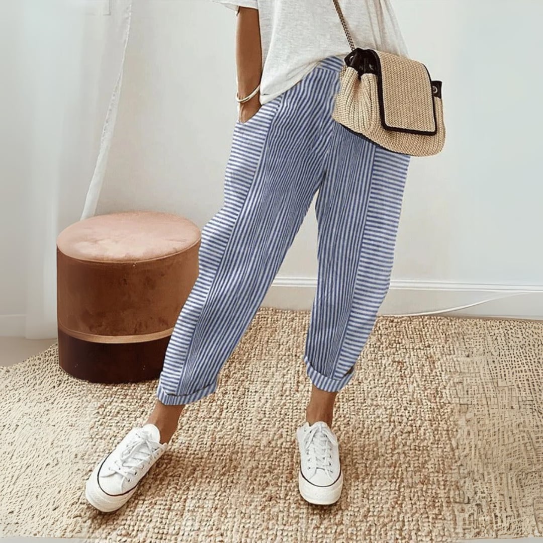 Women's striped wide leg pants styled with a tucked-in top and sandals for a casual look