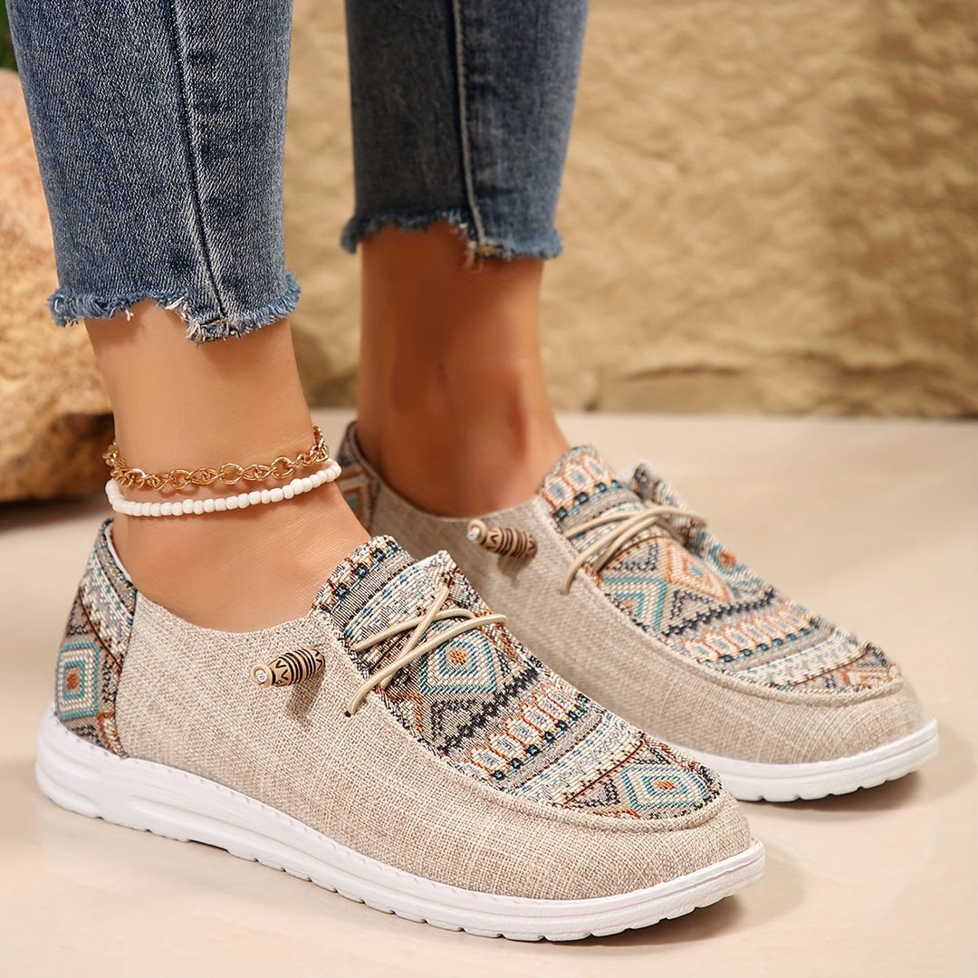 Overhead flat-lay of Clementine khaki tribal sneakers on neutral background