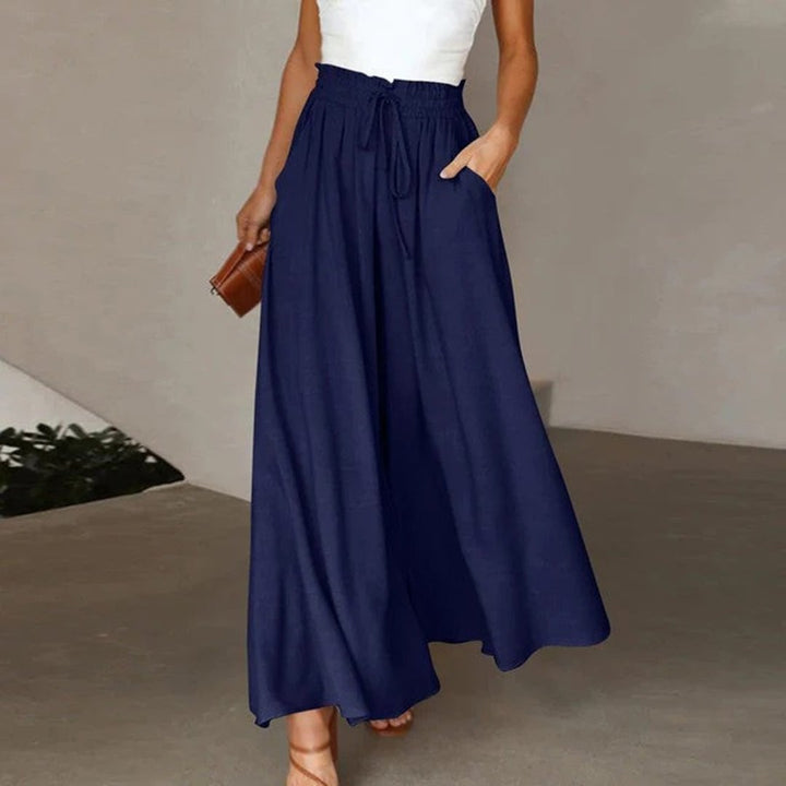 Side view of wide leg palazzo pants showing full length drape and high waist detail