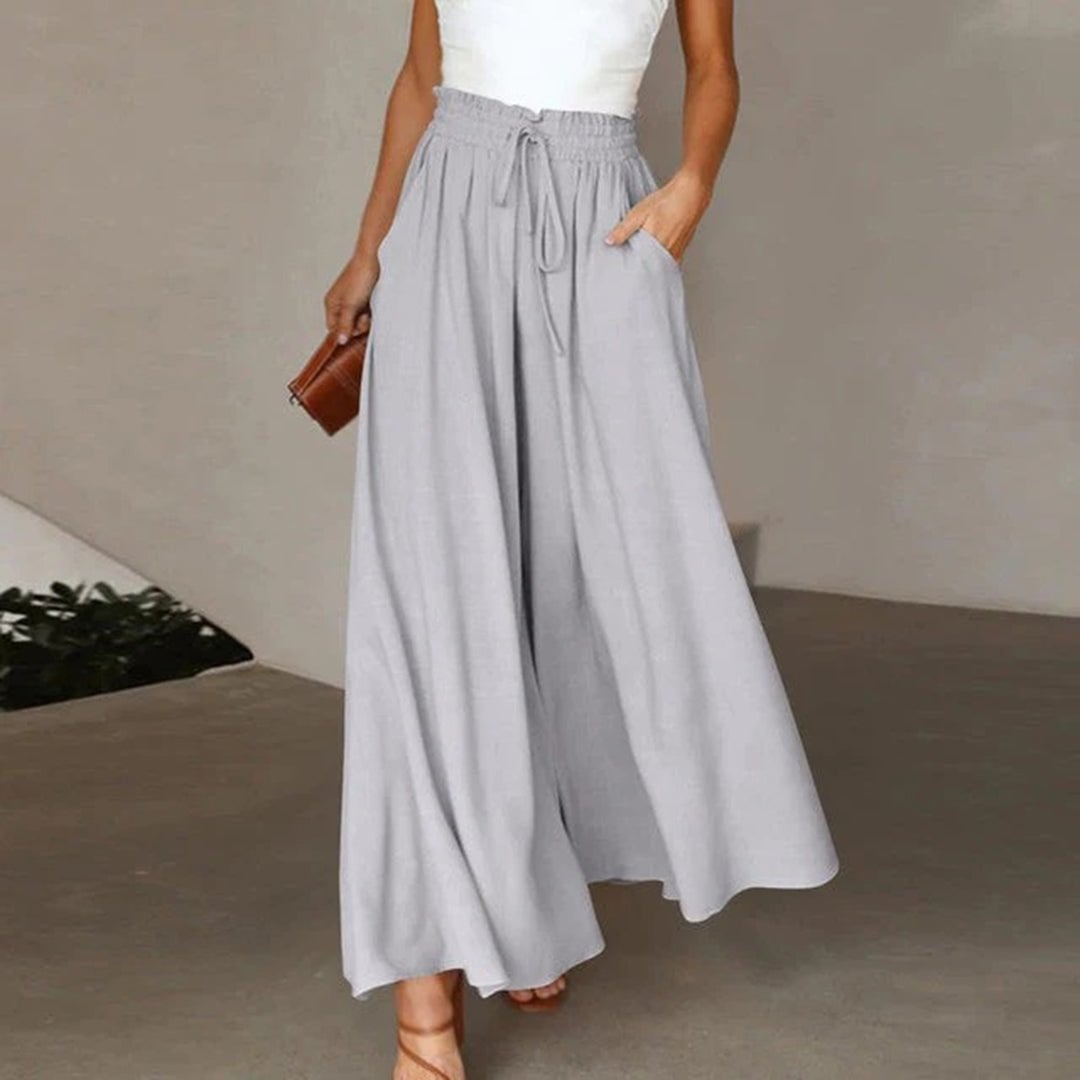 Women's palazzo pants in red with wide leg cut styled with a tucked-in blouse
