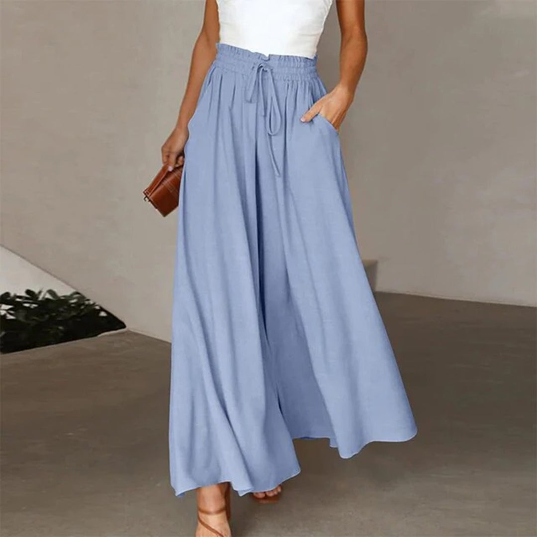 Back view of high waisted palazzo pants in gray showing flowing fabric movement
