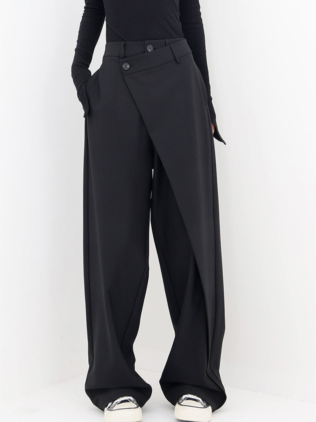 Front view of Cleo modern baggy trousers with asymmetric waistband in black