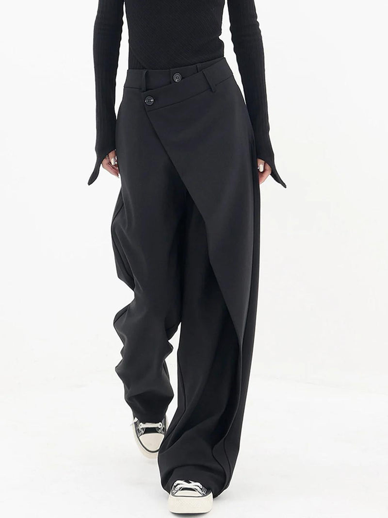 Back view of Cleo baggy trousers showing relaxed fit and asymmetric waistband detail