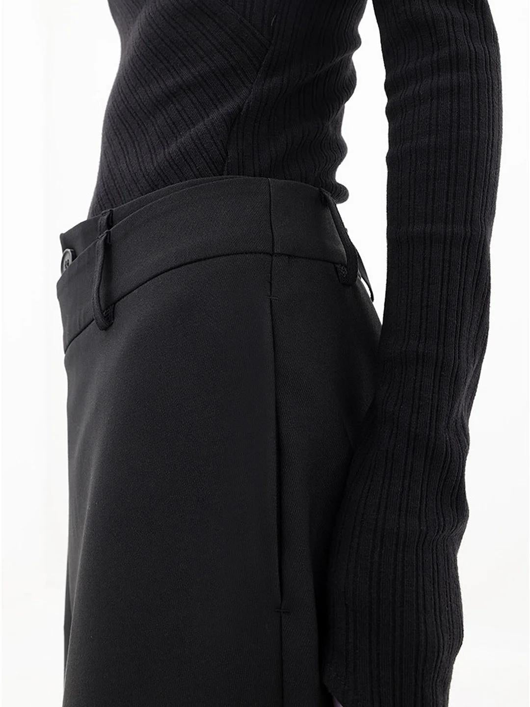 Model wearing Cleo black baggy trousers styled with a fitted top and heels