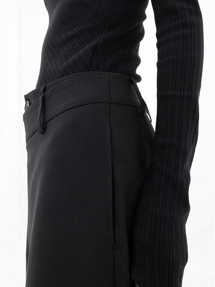 Model wearing Cleo black baggy trousers styled with a fitted top and heels