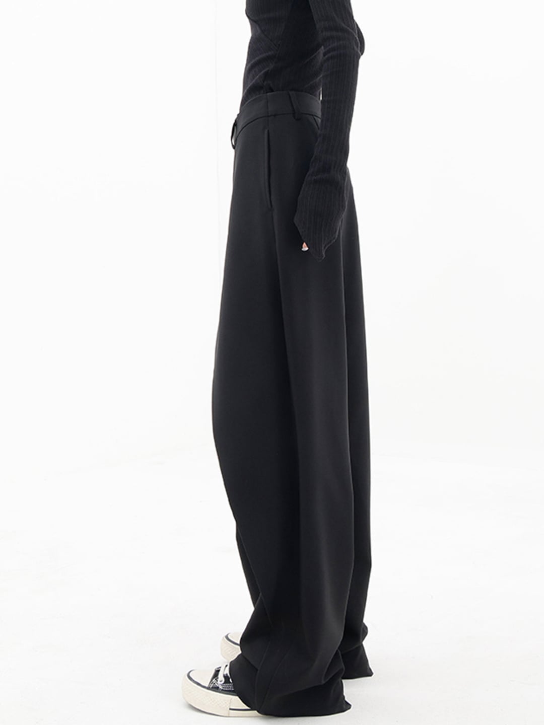 Model wearing Cleo grey trousers in a casual daytime outfit with sneakers