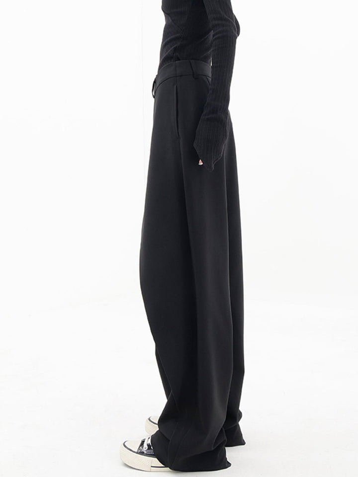 Model wearing Cleo grey trousers in a casual daytime outfit with sneakers