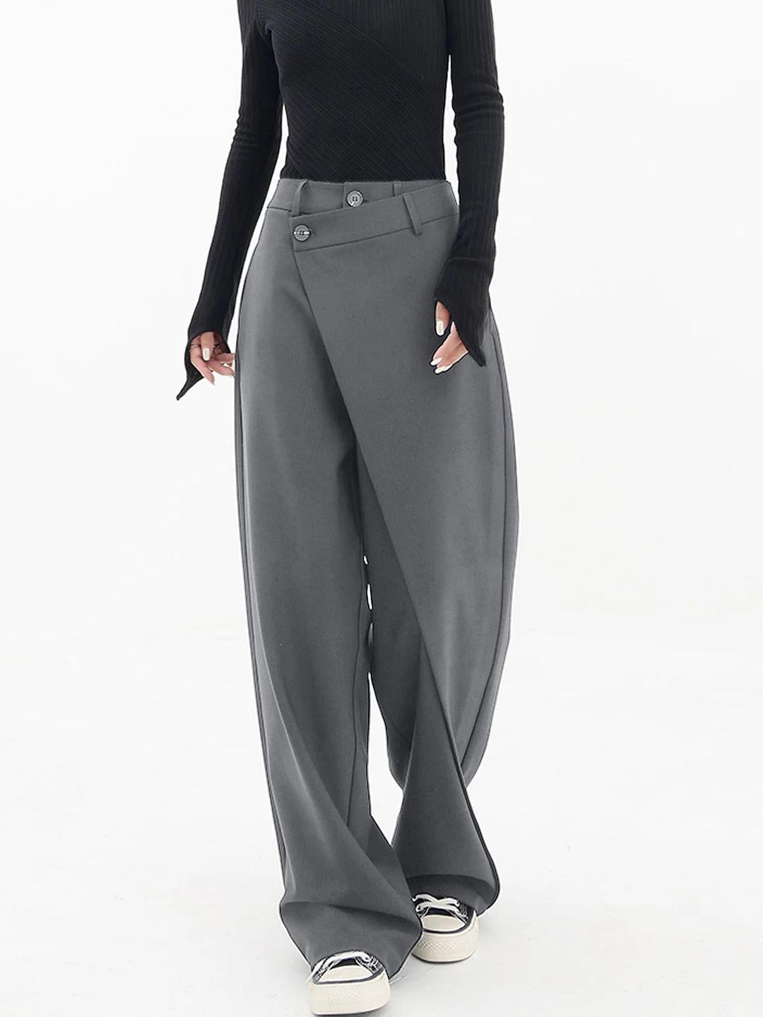 Detail shot of Cleo trousers button closure and asymmetric waistband in grey