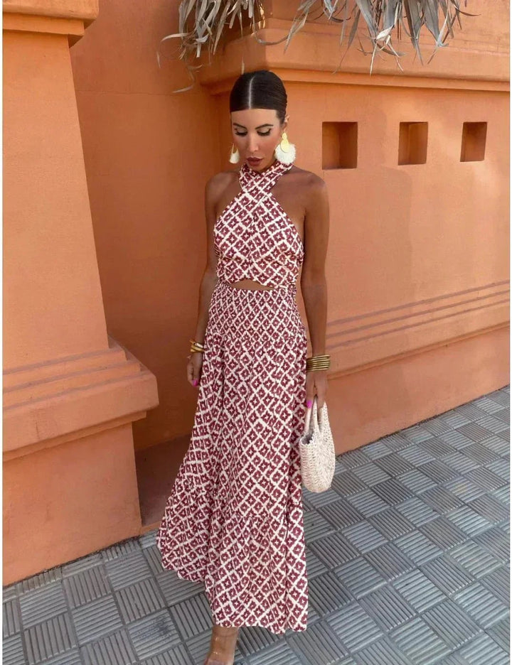 Full-length back view of the Cleo red summer dress with elegant sleeve detail and flowing hemline